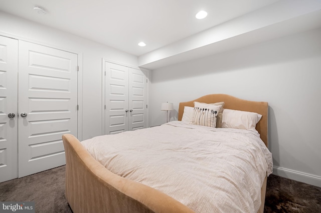 bedroom featuring carpet floors, recessed lighting, and two closets