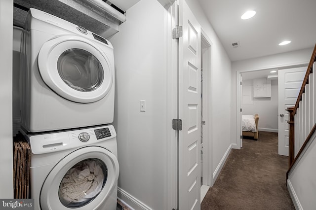 laundry room featuring baseboards, recessed lighting, carpet, stacked washer / dryer, and laundry area