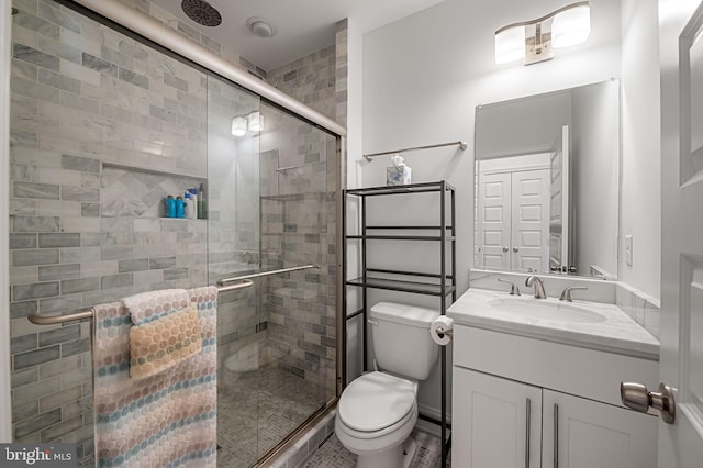 full bath with a stall shower, vanity, and toilet