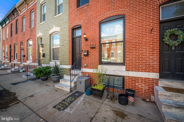 view of exterior entry with brick siding