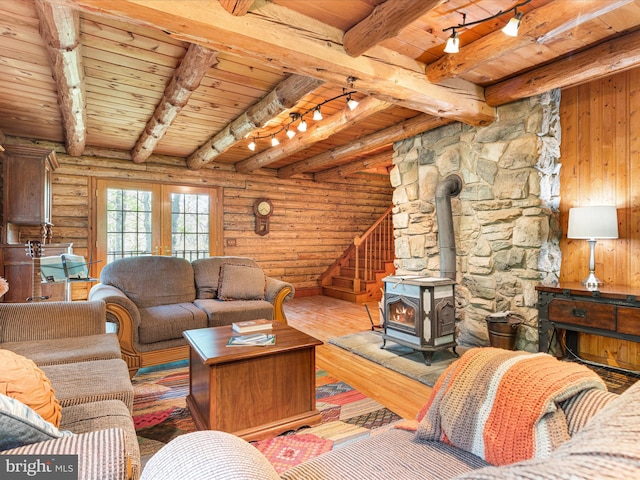 living room with wood-type flooring, rail lighting, a wood stove, and wooden ceiling