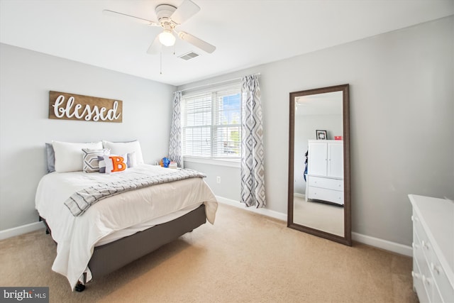 bedroom featuring visible vents, light carpet, and baseboards