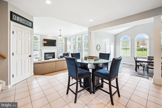 dining space featuring a glass covered fireplace, a healthy amount of sunlight, and recessed lighting