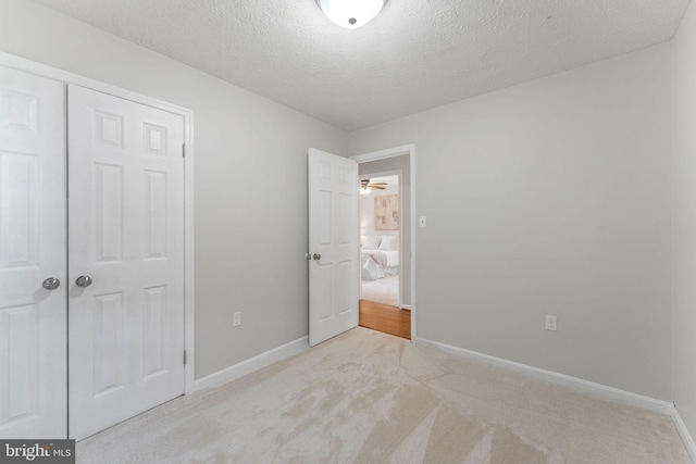 2116 Bell Tree Ln, Waldorf, MD 20601 - unfurnished bedroom featuring carpet flooring, baseboards, a closet, and a textured ceiling