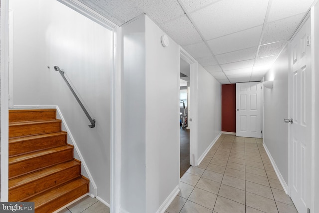 2116 Bell Tree Ln, Waldorf, MD 20601 - hallway featuring light tile patterned flooring, a drop ceiling, stairs, and baseboards