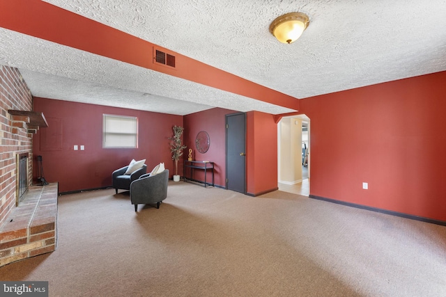 2116 Bell Tree Ln, Waldorf, MD 20601 - living room featuring a textured ceiling, carpet flooring, a brick fireplace, and baseboards