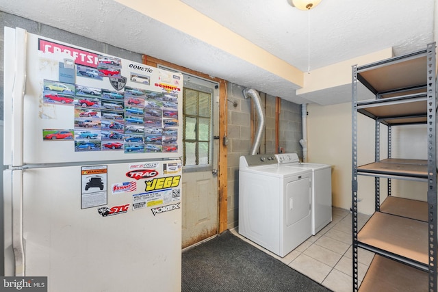 2116 Bell Tree Ln, Waldorf, MD 20601 - washroom featuring washing machine and clothes dryer, tile patterned flooring, and a textured ceiling