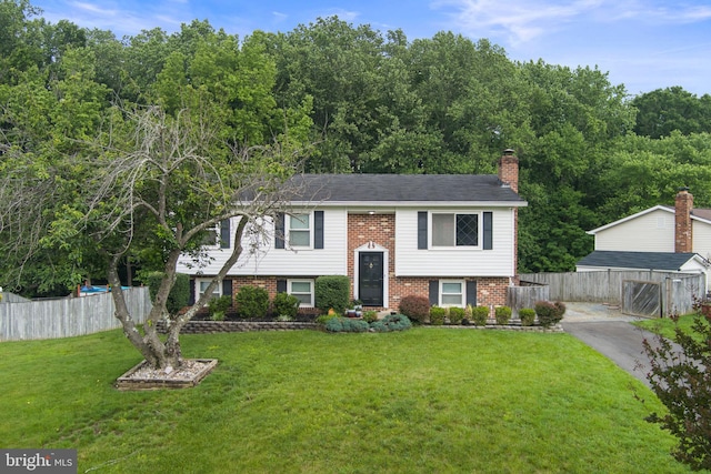 2116 Bell Tree Ln, Waldorf, MD 20601 - bi-level home with brick siding, a chimney, and driveway