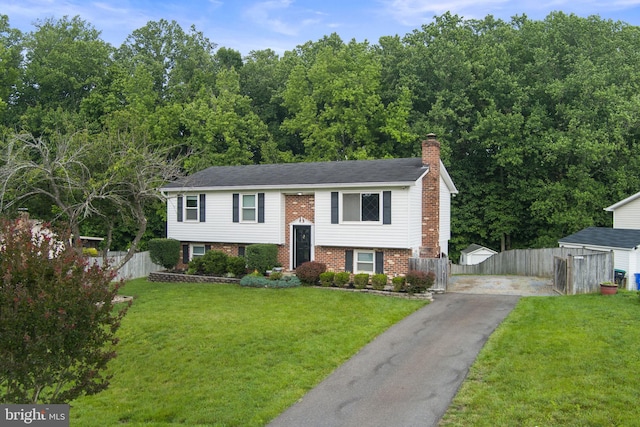 2116 Bell Tree Ln, Waldorf, MD 20601 - bi-level home with asphalt driveway, a chimney, and brick siding
