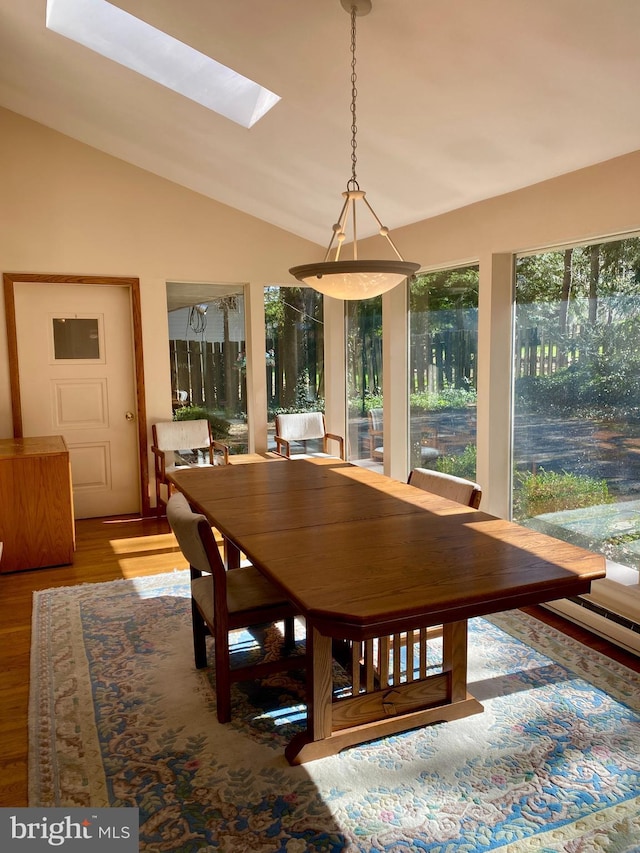 490 Orlando Ave, State College, PA 16803 - dining room with vaulted ceiling, wood finished floors, and a skylight