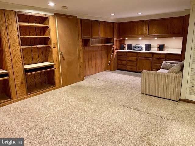 490 Orlando Ave, State College, PA 16803 - kitchen with carpet floors, brown cabinets, light countertops, open floor plan, and wooden walls