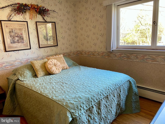 490 Orlando Ave, State College, PA 16803 - bedroom with a baseboard heating unit, wallpapered walls, wood finished floors, and wainscoting