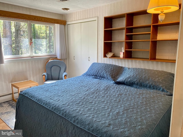 490 Orlando Ave, State College, PA 16803 - bedroom with a textured ceiling, wood finished floors, and a closet