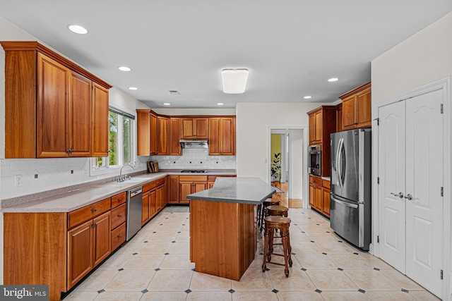 kitchen featuring a breakfast bar area, a center island, recessed lighting, and appliances with stainless steel finishes