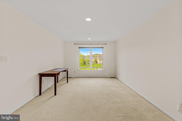 carpeted spare room featuring baseboards and recessed lighting