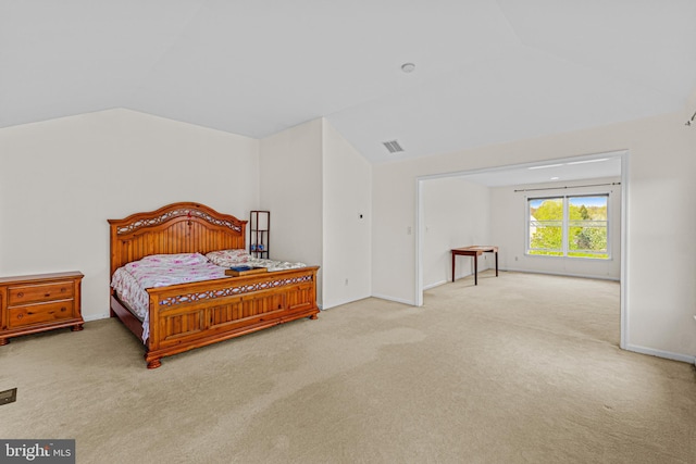 carpeted bedroom with vaulted ceiling, visible vents, and baseboards
