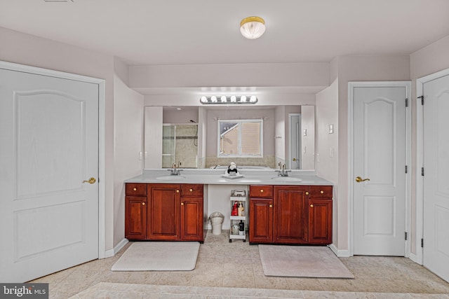 bathroom featuring tile patterned flooring, a sink, a shower stall, and double vanity