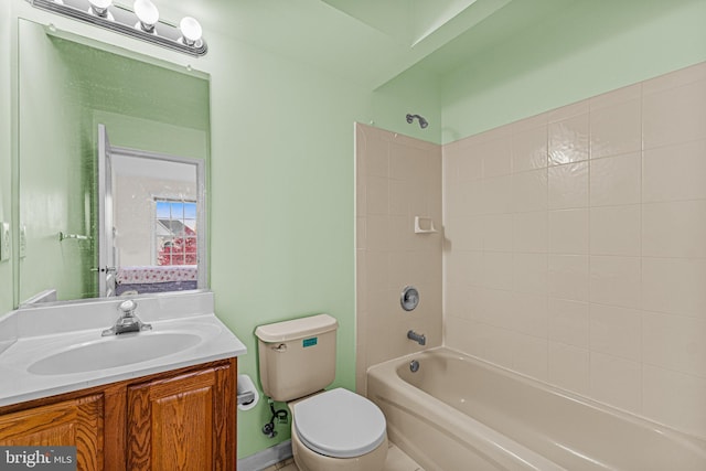 bathroom with bathing tub / shower combination, vanity, and toilet