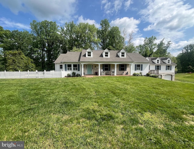 view of front of property with an attached garage, a front lawn, fence, and covered porch