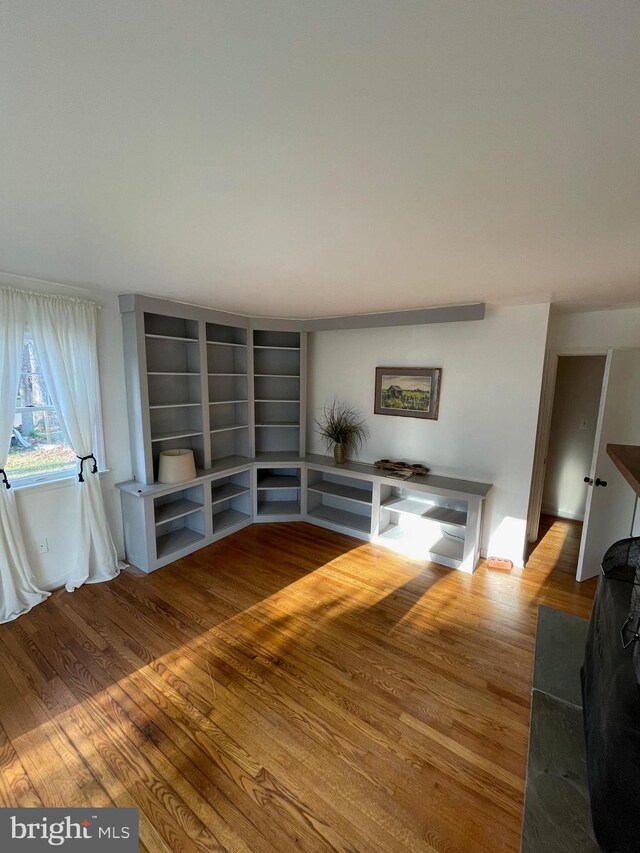 unfurnished living room featuring wood finished floors