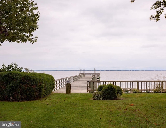 dock area featuring a yard and a water view