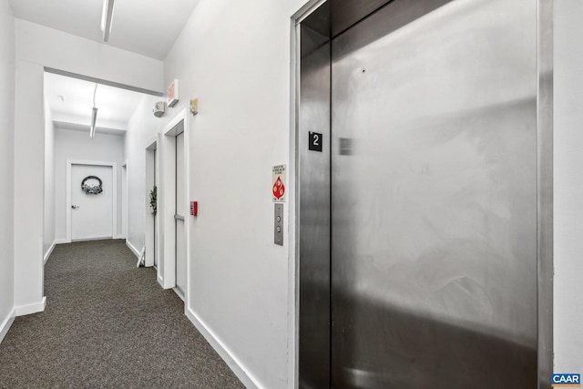 820 E High St Unit 1, Charlottesville, VA 22902 - corridor featuring elevator, baseboards, and dark carpet