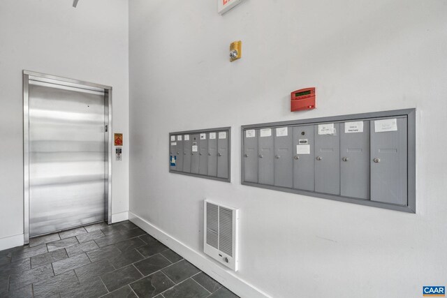 820 E High St Unit 1, Charlottesville, VA 22902 - entrance foyer featuring mail area, visible vents, stone finish floor, elevator, and baseboards