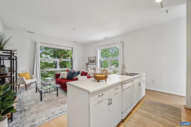 820 E High St Unit 1, Charlottesville, VA 22902 - kitchen featuring white cabinets, a sink, light countertops, dishwasher, and an island with sink