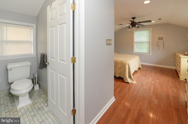 bedroom with lofted ceiling, light wood-style floors, baseboards, and recessed lighting