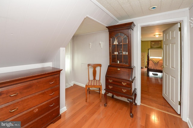 living area with light wood-type flooring and baseboards