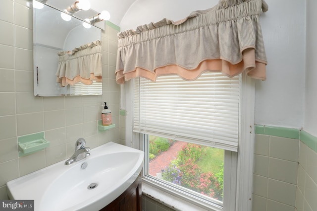 bathroom with tile walls and vanity