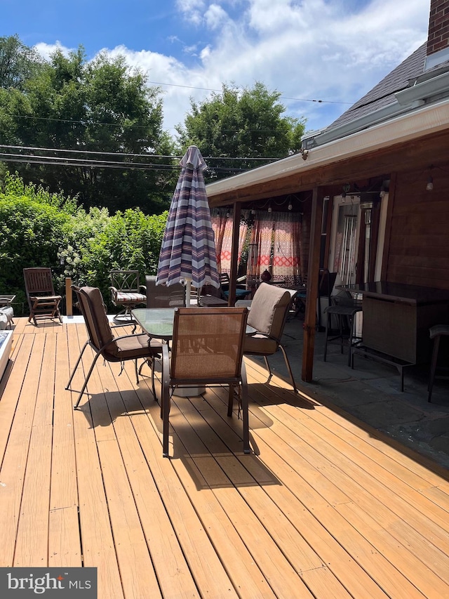 wooden terrace featuring outdoor dining area