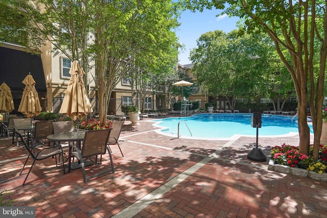 pool with fence and a patio area