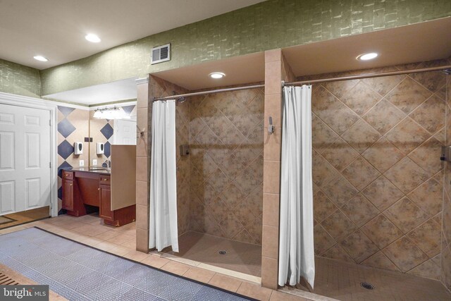full bath with visible vents, a shower stall, and vanity