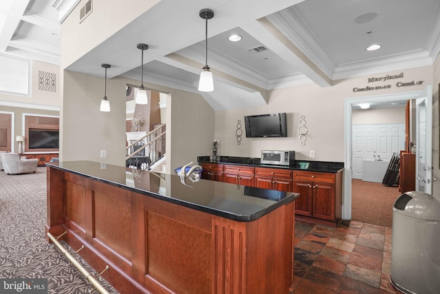 kitchen featuring crown molding, visible vents, and dark countertops