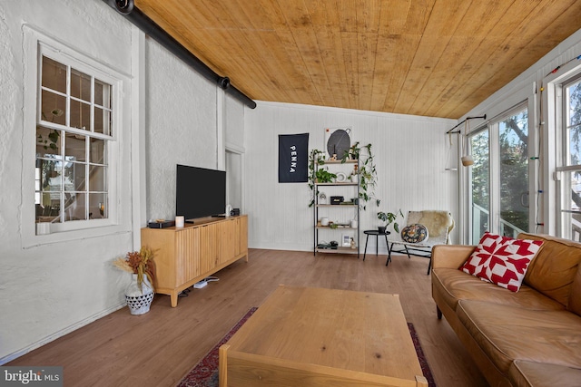living room with wooden ceiling, baseboards, and wood finished floors
