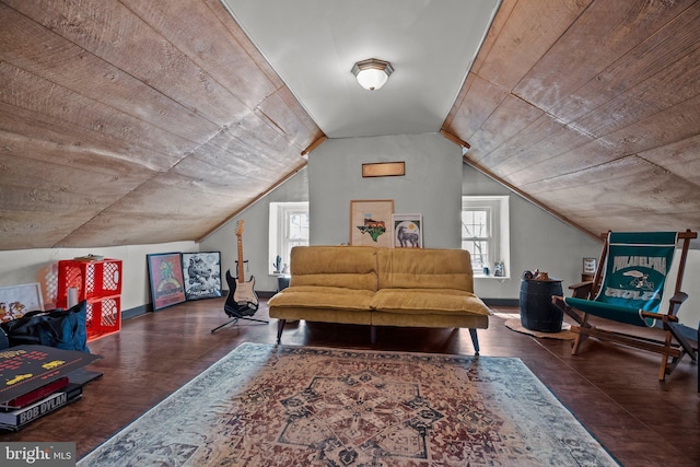 living area featuring lofted ceiling, wood finished floors, and baseboards