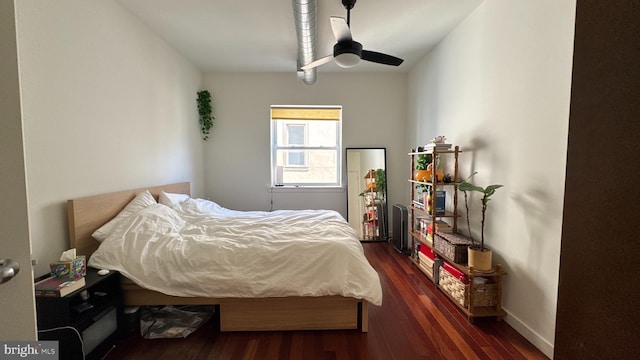 bedroom with ceiling fan, baseboards, and dark wood-style floors