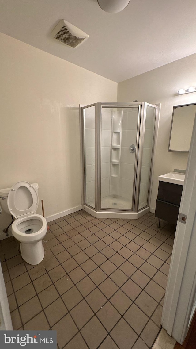bathroom with a shower stall, tile patterned floors, visible vents, vanity, and baseboards
