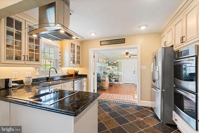 1217 Stafford Ave, Fredericksburg, VA 22401 - kitchen featuring island range hood, appliances with stainless steel finishes, a sink, glass insert cabinets, and cream cabinetry