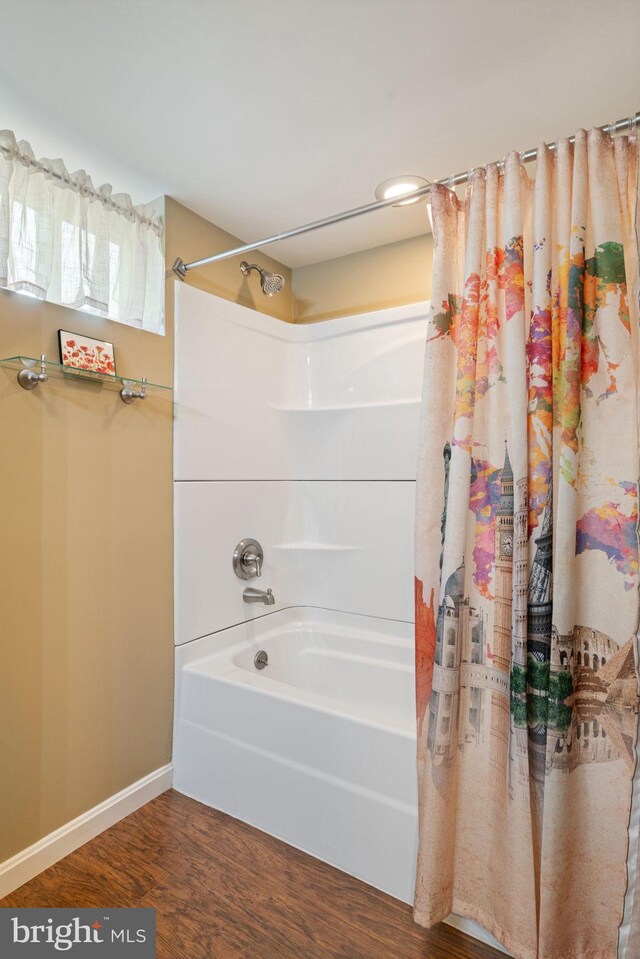 1217 Stafford Ave, Fredericksburg, VA 22401 - full bathroom with baseboards, wood finished floors, and shower / bath combo with shower curtain
