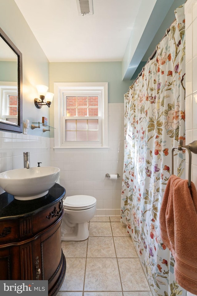 1217 Stafford Ave, Fredericksburg, VA 22401 - full bath with visible vents, vanity, tile patterned flooring, toilet, and tile walls