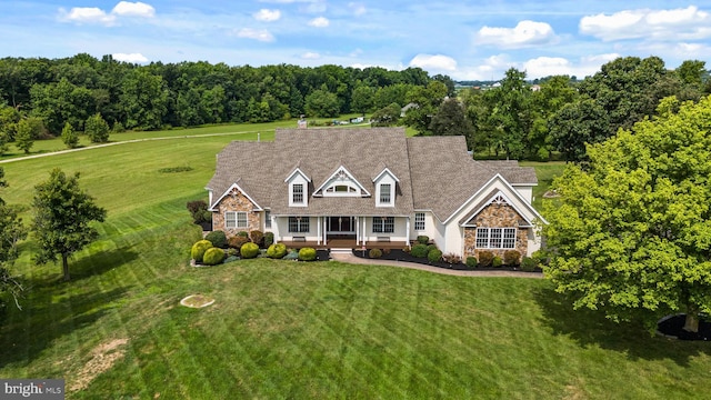 81 Stewart Rd, Pilesgrove, NJ 08098 - cape cod-style house featuring a front lawn, roof with shingles, stone siding, and covered porch