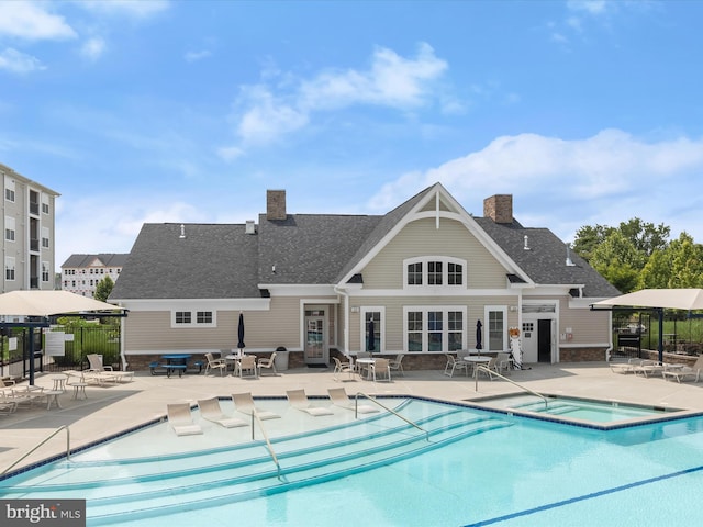 601 Quicksilver Ct Unit 401, Reisterstown, MD 21136 - community pool featuring a hot tub and a patio