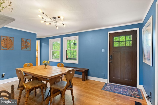 11713 Henderson Rd, Clifton, VA 20124 - dining area featuring a chandelier, baseboards, light wood-type flooring, and crown molding
