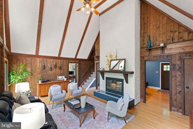 11713 Henderson Rd, Clifton, VA 20124 - living room featuring wood walls, beamed ceiling, light wood-type flooring, ceiling fan, and high vaulted ceiling