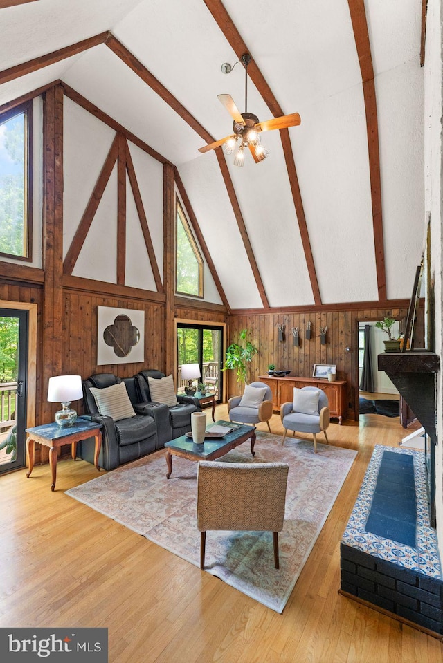 11713 Henderson Rd, Clifton, VA 20124 - living area featuring high vaulted ceiling, wooden walls, beam ceiling, plenty of natural light, and wood finished floors