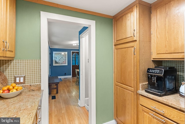 11713 Henderson Rd, Clifton, VA 20124 - kitchen with ornamental molding, tasteful backsplash, light wood finished floors, baseboards, and light stone countertops