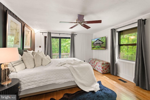 11713 Henderson Rd, Clifton, VA 20124 - bedroom with multiple windows, wood finished floors, access to outside, and a ceiling fan