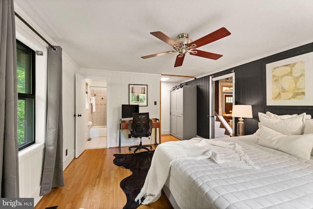 11713 Henderson Rd, Clifton, VA 20124 - bedroom with ornamental molding, multiple windows, light wood-style floors, a desk, and connected bathroom